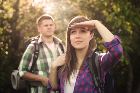 Young couple in forest at sunsetの写真素材