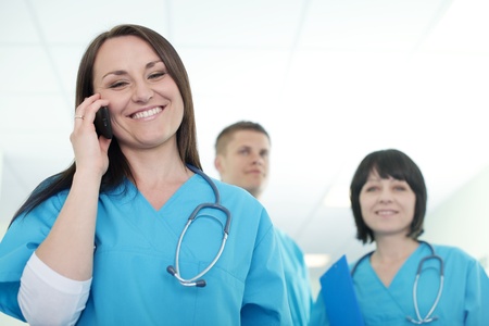 Female surgeon talking on mobile phoneの写真素材