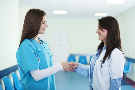Doctors shaking hands in hospitalの写真素材