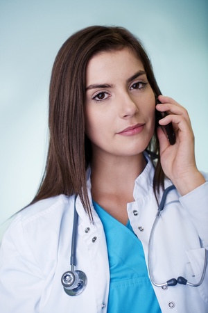 Young female doctor on the phoneの写真素材