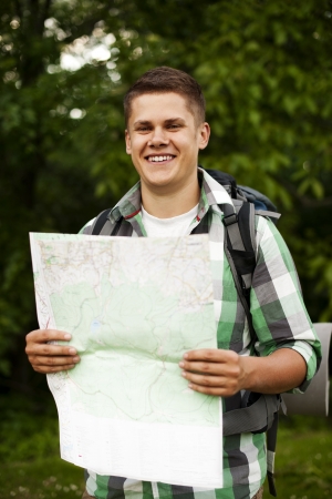 Man holding a map in forestの写真素材