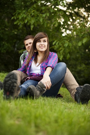 Young couple sitting on gladeの写真素材
