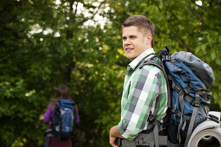 Young couple walking through forestの写真素材
