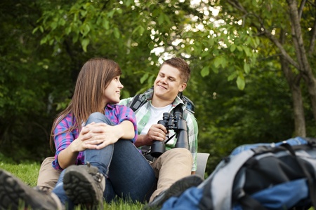 Young couple sitting on gladeの写真素材