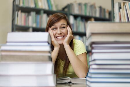 Cute student in libraryの写真素材