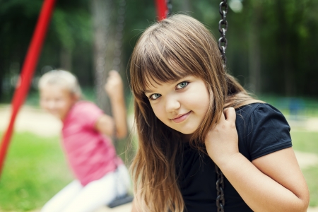 Little girl smiling on swingの写真素材