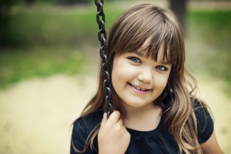 Portrait of smiling girl on swingの写真素材