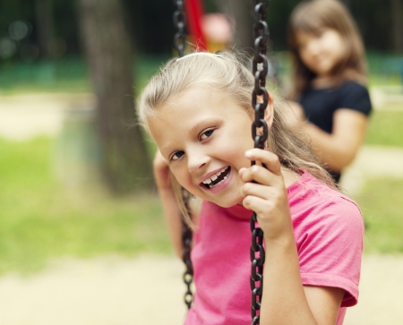 Happy little kid on swingの写真素材
