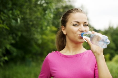 Young woman drinking waterの写真素材