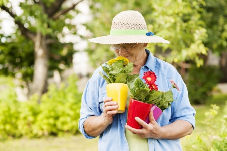 Senior woman smelling flowersの写真素材