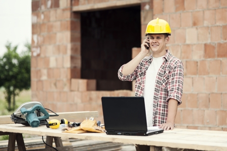 Carpenter talking on mobile phoneの写真素材
