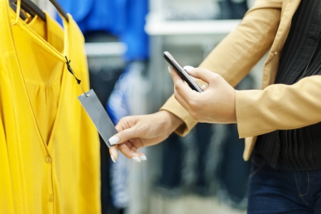Woman scanning QR code in shopping mallの写真素材