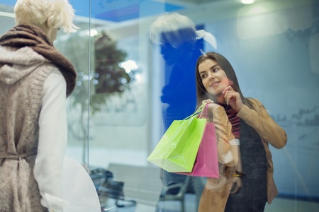 Young woman looking at shop windowの写真素材