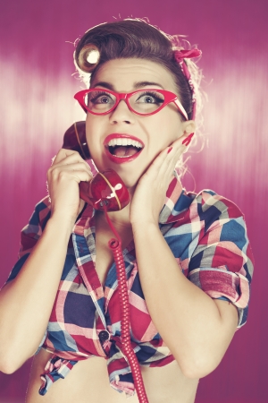 Cheerful retro woman on the phoneの写真素材
