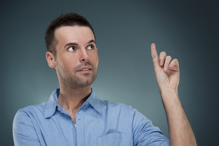 Handsome man pointing at copyspaceの写真素材