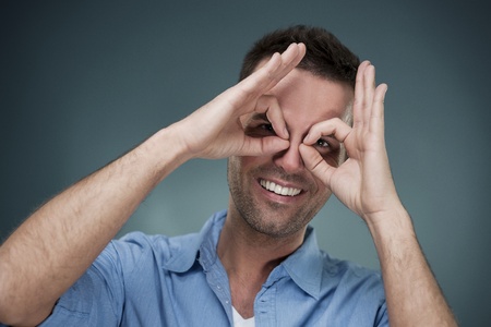 Cheerful man making hand gesture
