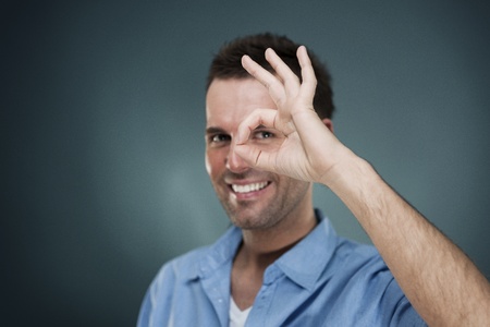 Attractive male showing OKの写真素材