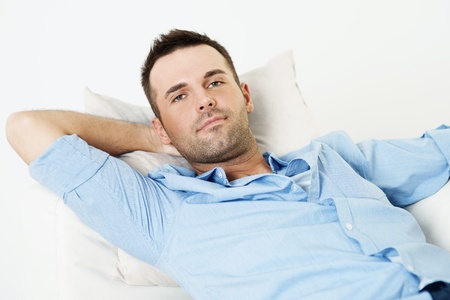Handsome man relaxing with hand behind headの写真素材