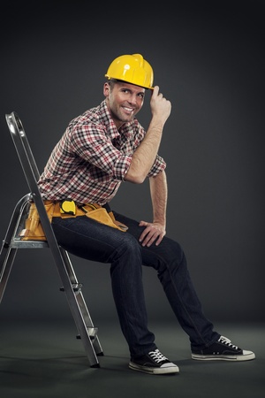Construction worker sitting on a ladderの写真素材