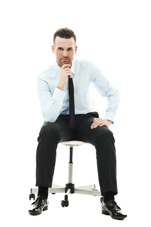 Pensive businessman sitting on chairの写真素材
