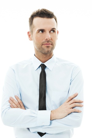 Handsome businessman with arms crossed looking awayの写真素材