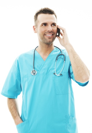Handsome male surgeon talking on a mobile phoneの写真素材