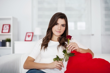 Beautiful woman with red roseの写真素材