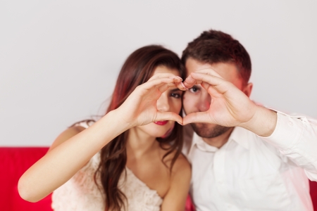 Couple making a heart shape with their handsの写真素材