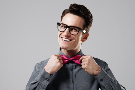 Smiling man with pink bow tieの写真素材