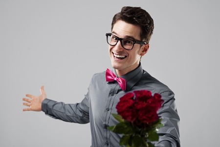 Cute nerd with a bouquet of rosesの写真素材