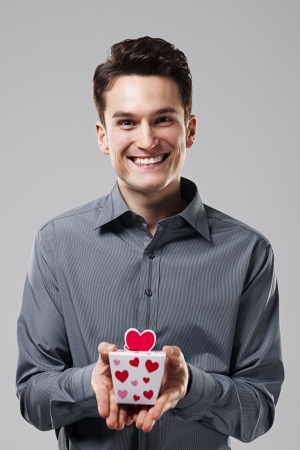 Man holding in his hands the love giftの写真素材