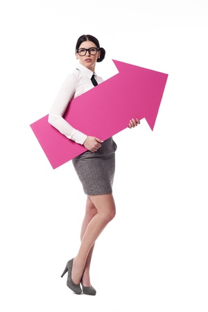 Gorgeous businesswoman holding pink arrow sign の写真素材