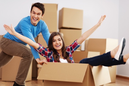 Couple having fun in new home の写真素材