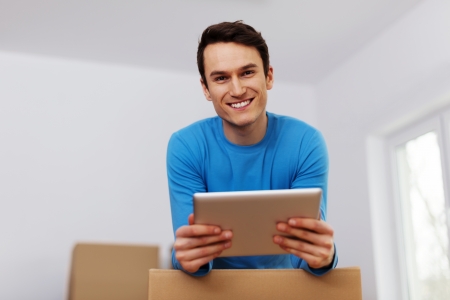 Happy man organize relocation in his new apartment の写真素材