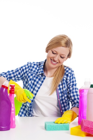 Cheerful woman cleaning the tableの写真素材