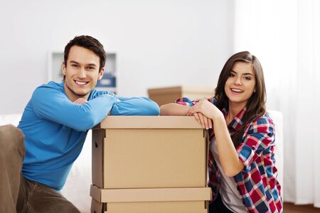 Portrait of young couple with moving boxesの写真素材