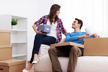 Loving couple unpacking in their new home の写真素材