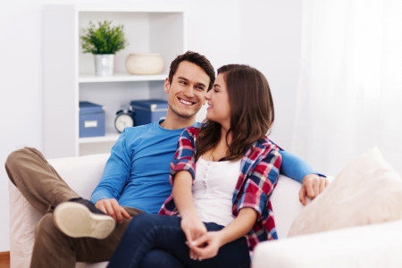 Loving couple sitting in living roomの写真素材