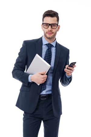Handsome young businessman with a digital tablet and mobile phoneの写真素材