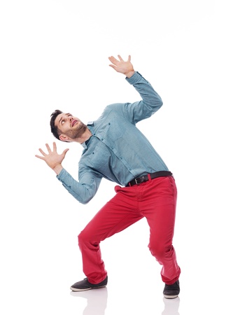 Young man bending under the weight of somethingの写真素材