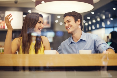 Happy couple have fun in cafe の写真素材
