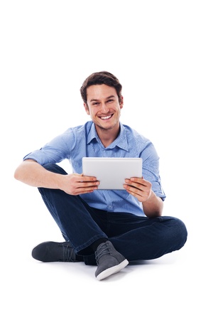 Sitting man using a digital tabletの写真素材