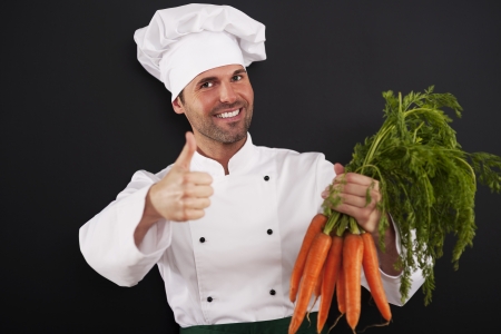 Chef with bunch of carrots showing thumbs upの写真素材