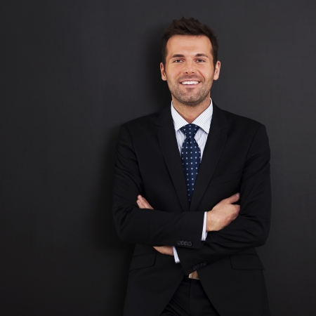 Smiling businessman with arms crossedの写真素材