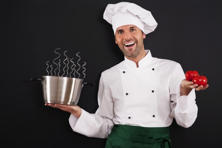 Happy chef recommending tomato soupの写真素材