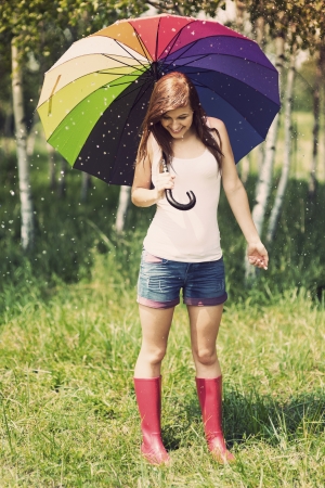 Smiling woman in rainy summer day の写真素材