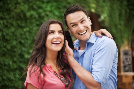 Happy young couple with smart phone の写真素材