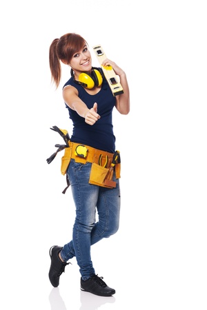 Young female construction worker showing OK sign の写真素材