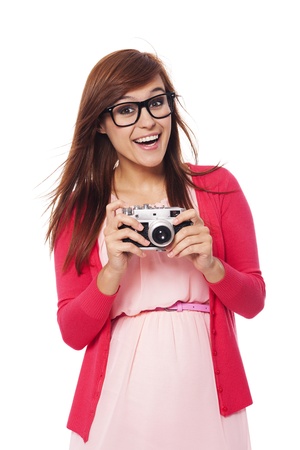 Excited woman holding in hands old cameraの写真素材