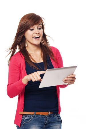 Happy young woman using digital tabletの写真素材
